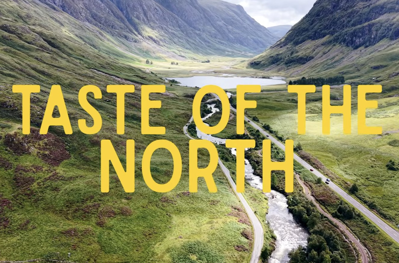 Taste of the North title card: bold yellow lettering over an aerial view of a road winding through a Highland glen beside a loch