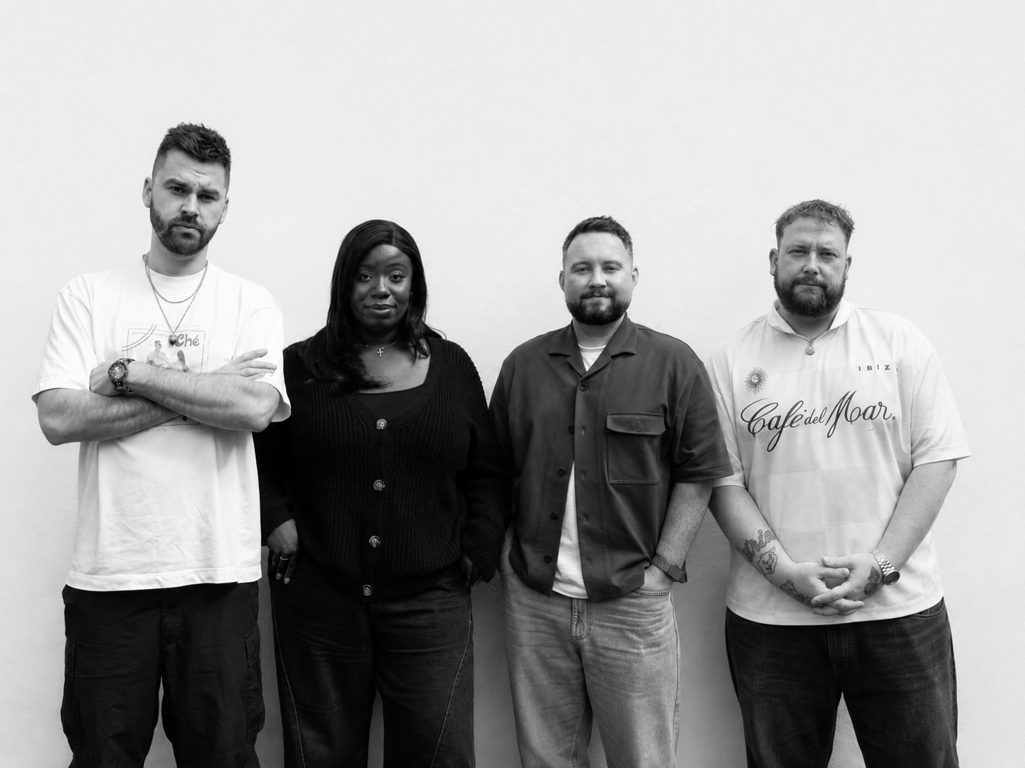 The CCA team standing together against a plain wall